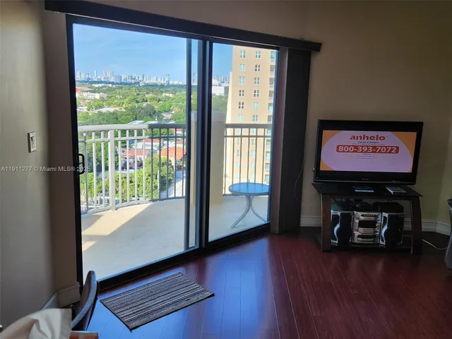 a view of a room with wooden floor and a window