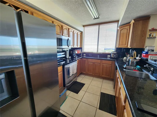 a kitchen with stainless steel appliances a sink stove and cabinets