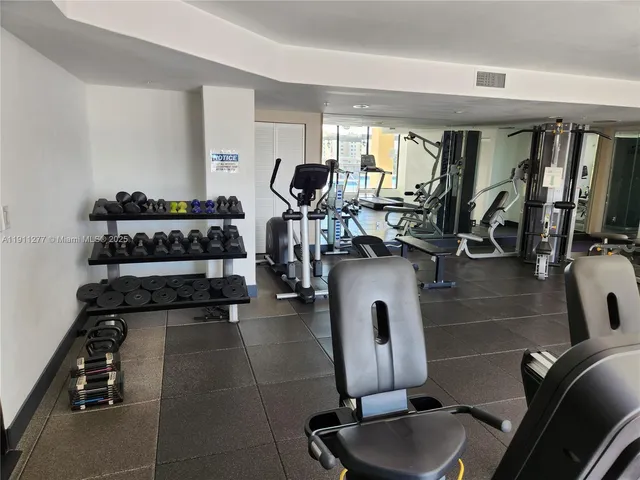 a room with gym equipment and windows