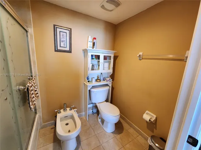 a white toilet sitting next to a bathroom sink