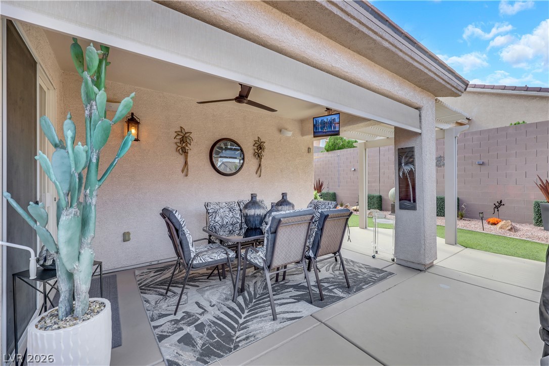 2635 Dirleton Place Henderson, NV 89044 - Photo 42 of 50 Sheltered outdoor dining space flows onto a concrete patio overlooking the tidy backyard.