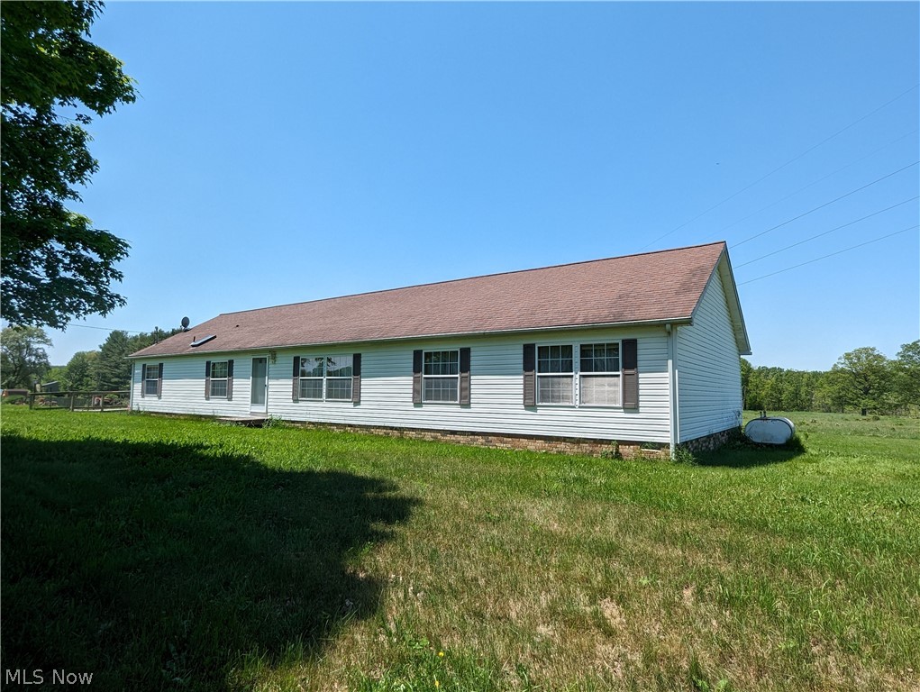 9889 Griffith Road Ravenna, OH 44266 - Photo 2 of 49 Rear view of house with a lawn