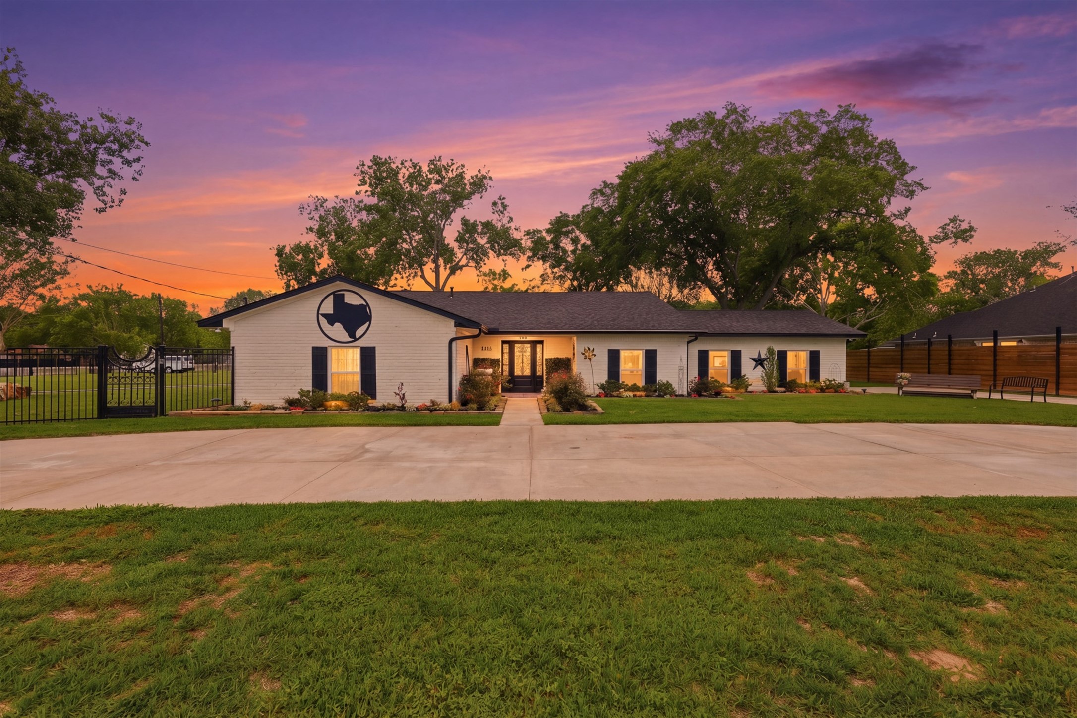 5111 Brookside Road Pearland, TX 77581 - Photo 1 of 42 Stunning twilight view highlighting the home's updated exterior, mature trees, and welcoming approach.