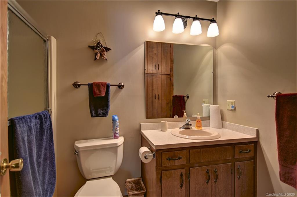 238 Raven Ridge Maggie Valley, NC 28751 - Photo 14 of 21 a bathroom with a toilet sink and mirror
