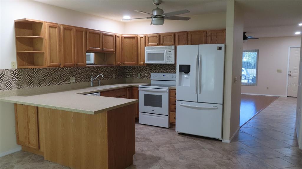 2291 Americus Boulevard West, Unit 7 Clearwater, FL 33763 - Photo 11 of 57 a kitchen that has a sink a refrigerator and a stove
