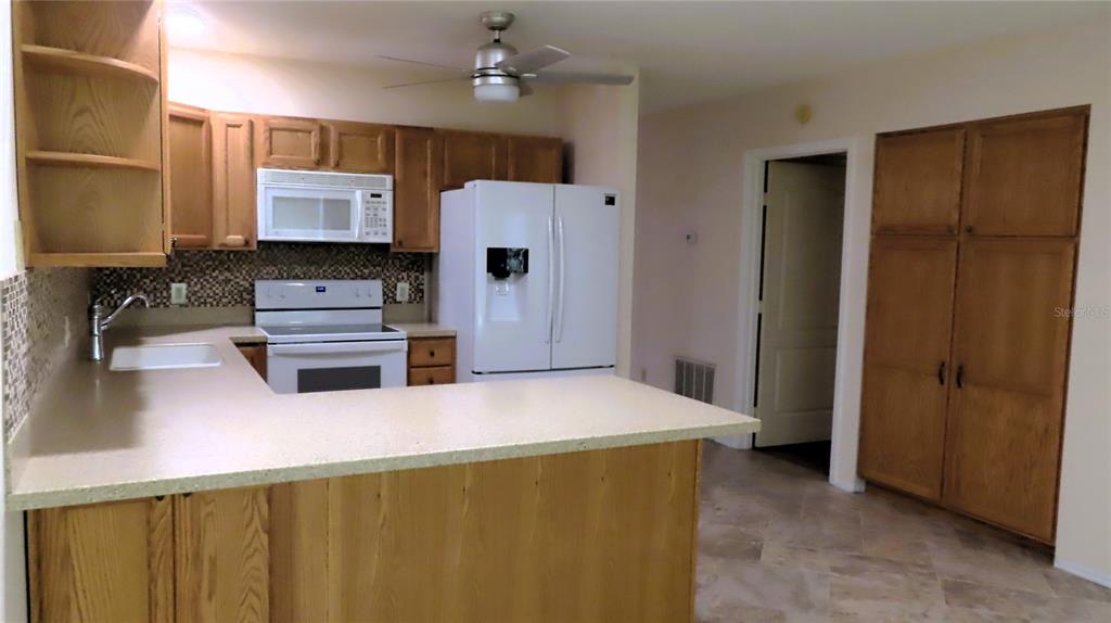 2291 Americus Boulevard West, Unit 7 Clearwater, FL 33763 - Photo 12 of 57 a kitchen with stainless steel appliances a refrigerator and a stove