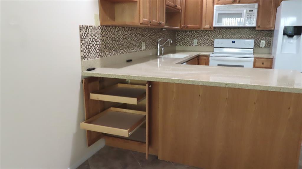 2291 Americus Boulevard West, Unit 7 Clearwater, FL 33763 - Photo 17 of 57 a kitchen with a sink cabinets and counter space