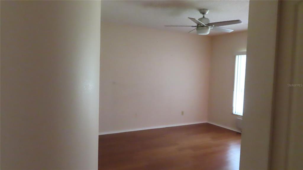 2291 Americus Boulevard West, Unit 7 Clearwater, FL 33763 - Photo 27 of 57 an empty room with a window and a fan