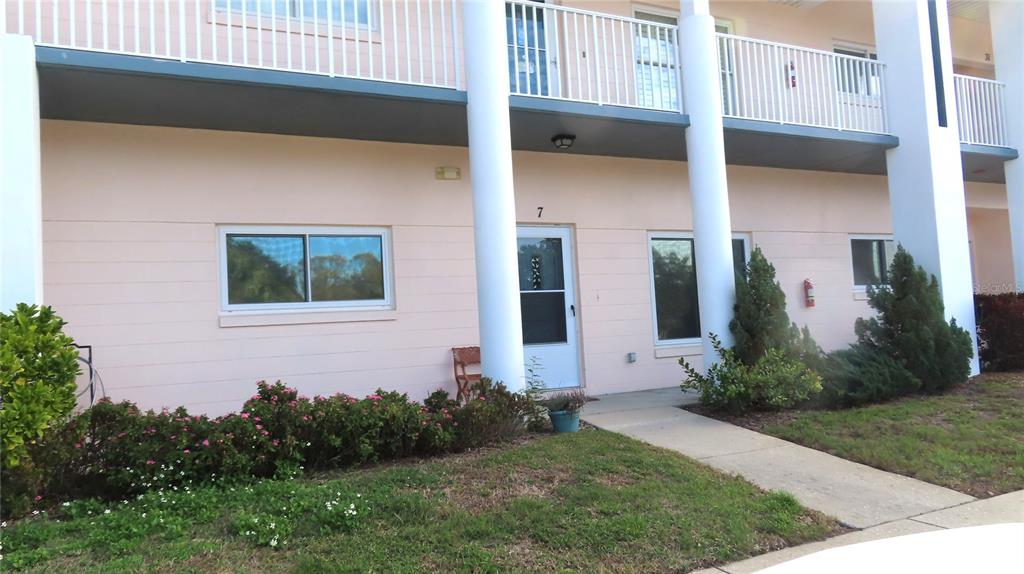 2291 Americus Boulevard West, Unit 7 Clearwater, FL 33763 - Photo 3 of 57 a front view of a house with garden