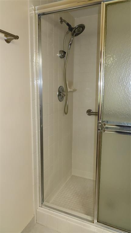 2291 Americus Boulevard West, Unit 7 Clearwater, FL 33763 - Photo 34 of 57 a bathroom with a glass shower door