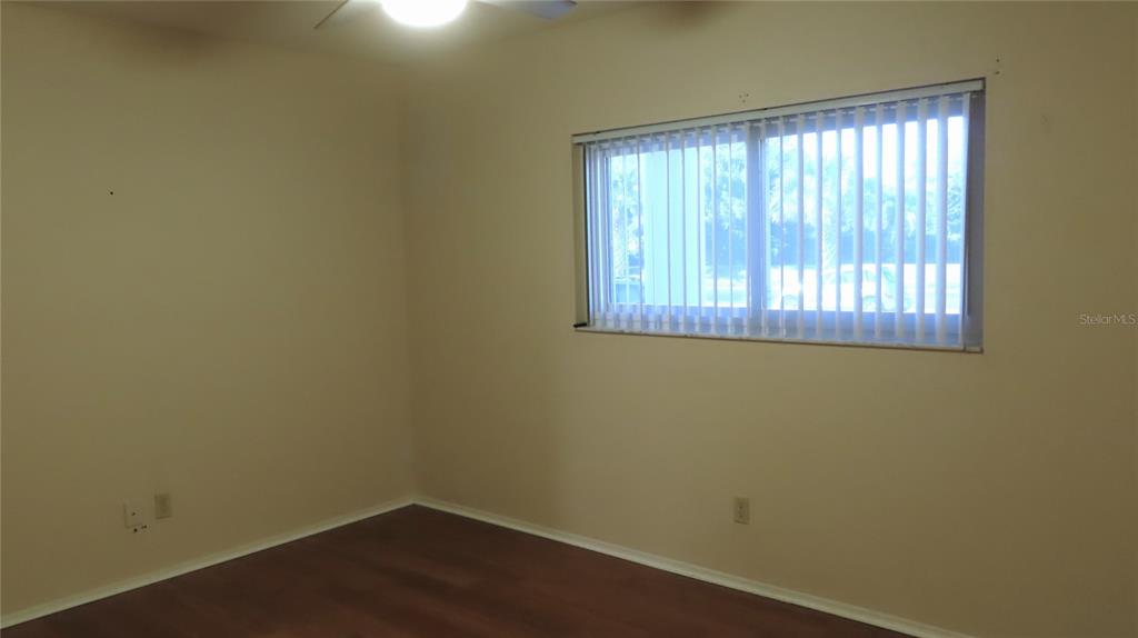 2291 Americus Boulevard West, Unit 7 Clearwater, FL 33763 - Photo 39 of 57 an empty room with a window