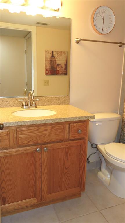 2291 Americus Boulevard West, Unit 7 Clearwater, FL 33763 - Photo 42 of 57 a bathroom with a sink a toilet and a mirror