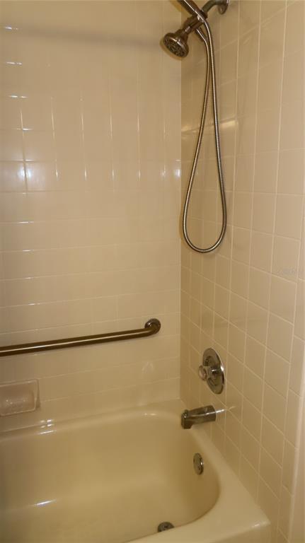 2291 Americus Boulevard West, Unit 7 Clearwater, FL 33763 - Photo 44 of 57 a bathroom with a bath tub with a shower