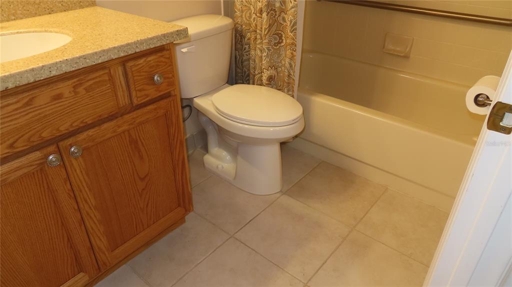 2291 Americus Boulevard West, Unit 7 Clearwater, FL 33763 - Photo 45 of 57 a bathroom with a toilet and a shower