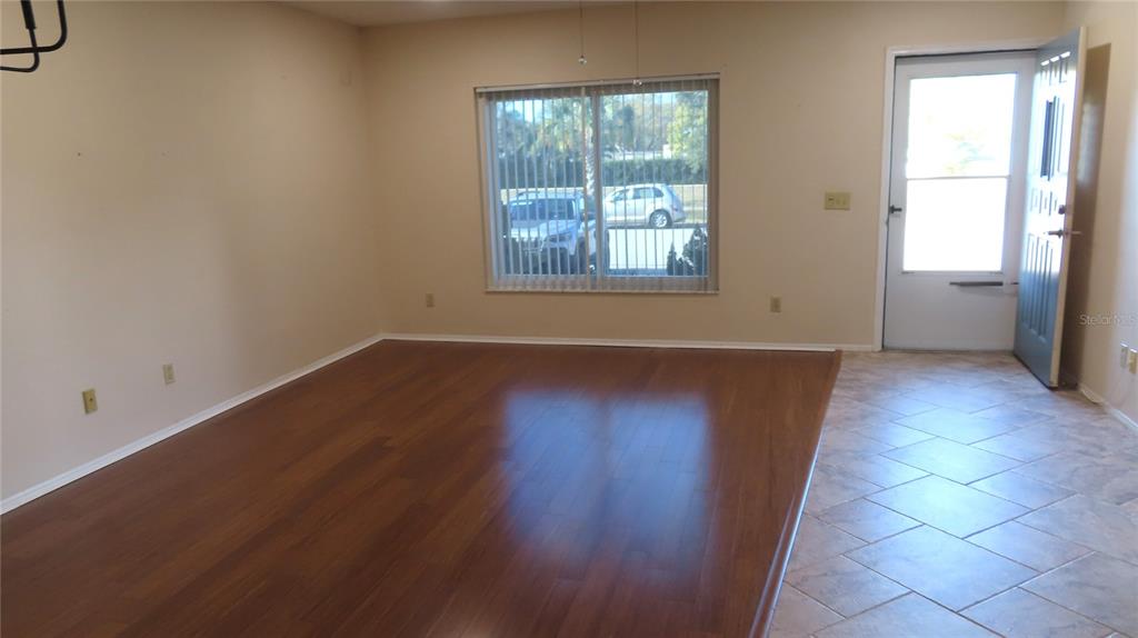 2291 Americus Boulevard West, Unit 7 Clearwater, FL 33763 - Photo 5 of 57 an empty room with wooden floor and windows