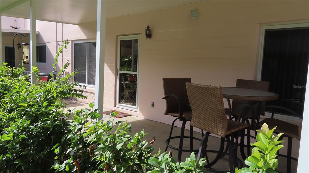 2291 Americus Boulevard West, Unit 7 Clearwater, FL 33763 - Photo 52 of 57 a view of a dinning table and chairs in patio