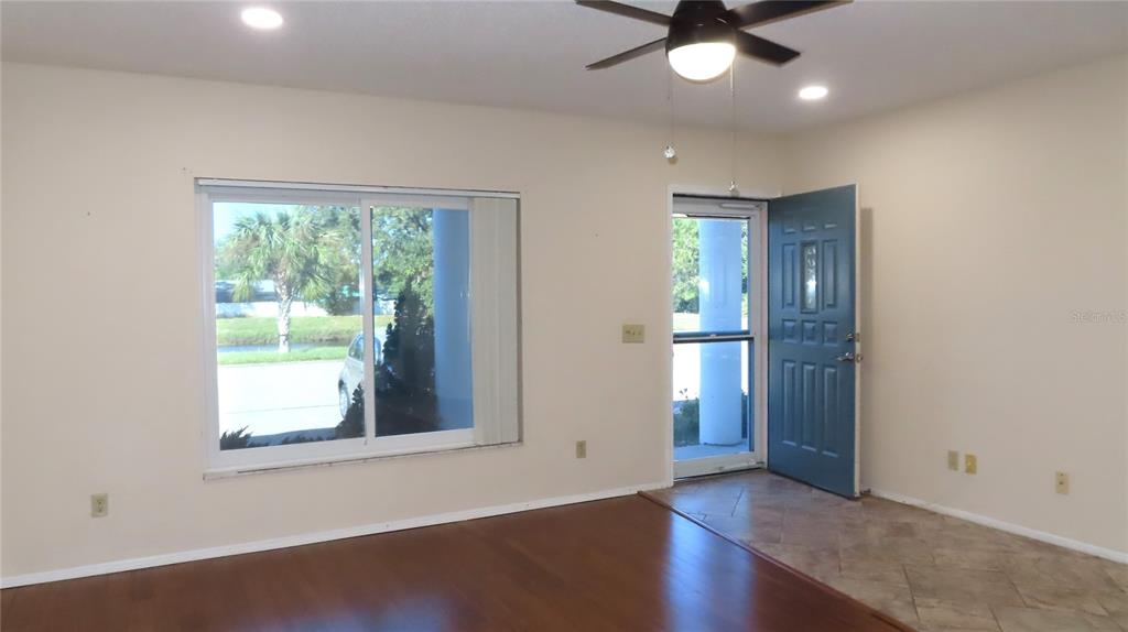 2291 Americus Boulevard West, Unit 7 Clearwater, FL 33763 - Photo 6 of 57 an empty room with wooden floor and a window