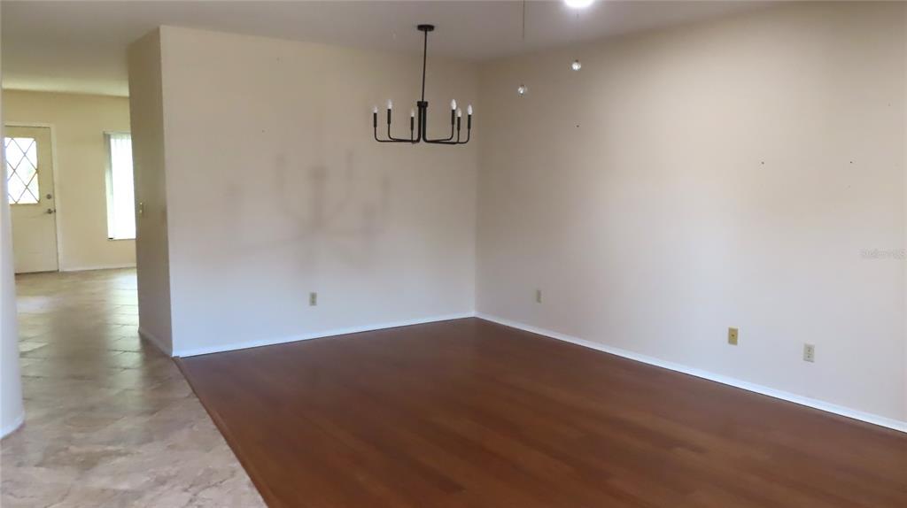 2291 Americus Boulevard West, Unit 7 Clearwater, FL 33763 - Photo 7 of 57 a view of a room with wooden floor and white walls
