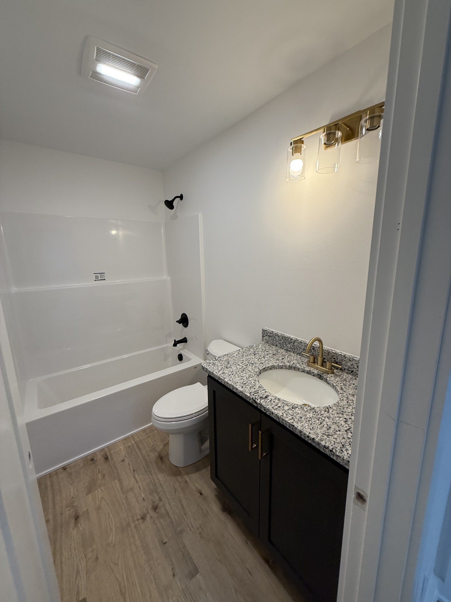 4827 Akersville Road Lafayette, TN 37083 - Photo 12 of 14 a bathroom with a granite countertop sink toilet and shower