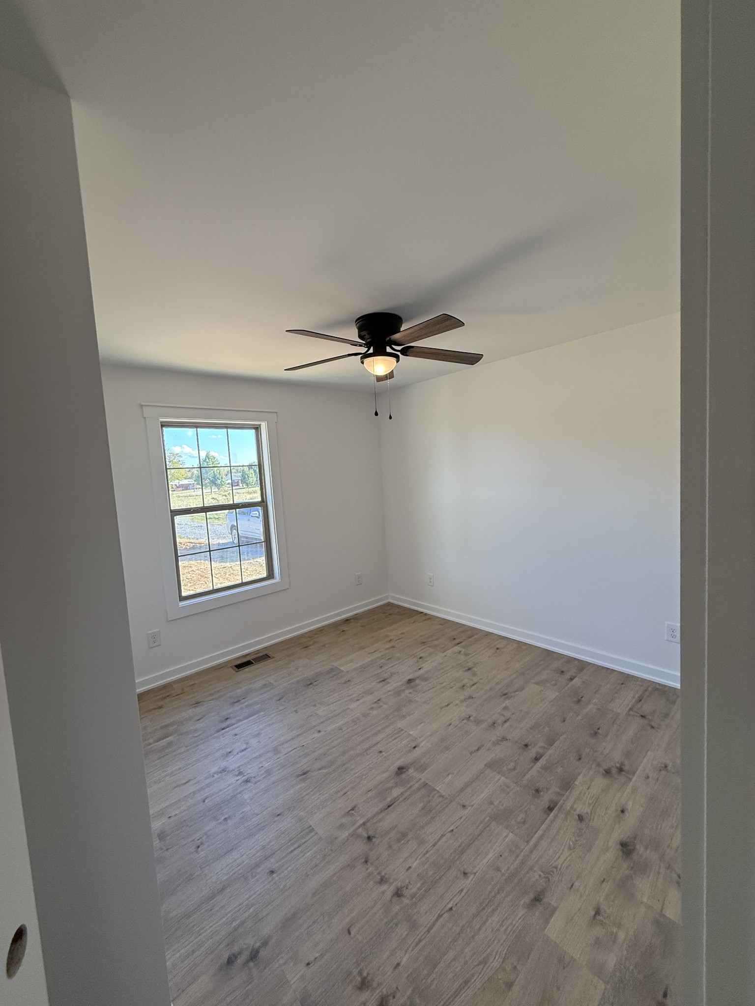 4827 Akersville Road Lafayette, TN 37083 - Photo 10 of 14 an empty room with windows and fan
