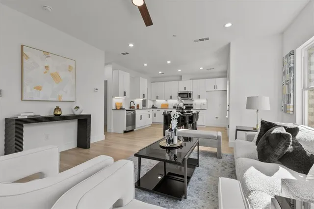 a living room with furniture and kitchen view