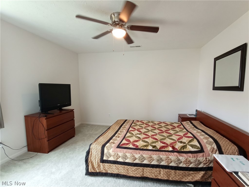 4509 Millbrook Way Akron, OH 44321 - Photo 23 of 27 Spacious room featuring light-colored carpeting, a ceiling fan with integrated lighting, and white wall finishes
