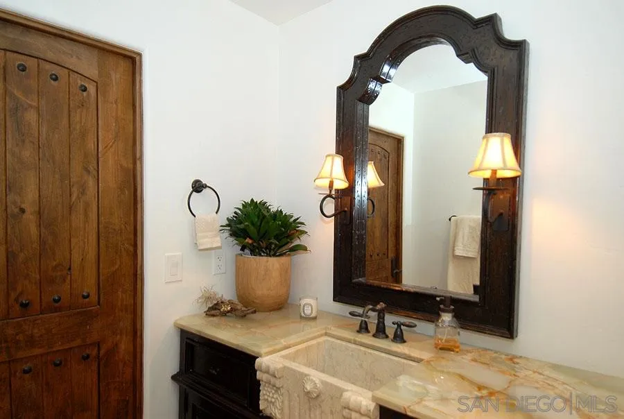 6511 Poco Lago Rancho Santa Fe, CA 92067 - Photo 13 of 24 a bathroom with a sink and a mirror