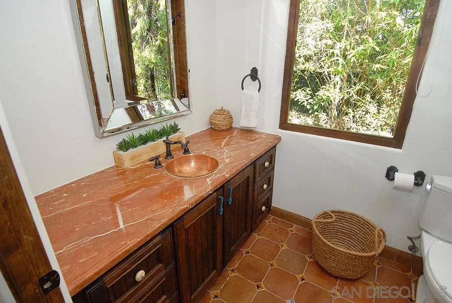 6511 Poco Lago Rancho Santa Fe, CA 92067 - Photo 15 of 24 a bathroom with a sink and a window
