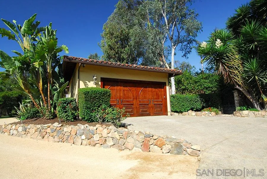6511 Poco Lago Rancho Santa Fe, CA 92067 - Photo 16 of 24 a front view of a house with a yard