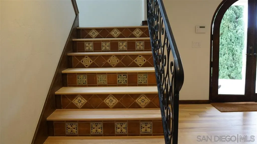 6511 Poco Lago Rancho Santa Fe, CA 92067 - Photo 17 of 24 a view of staircase with wooden floor and windows