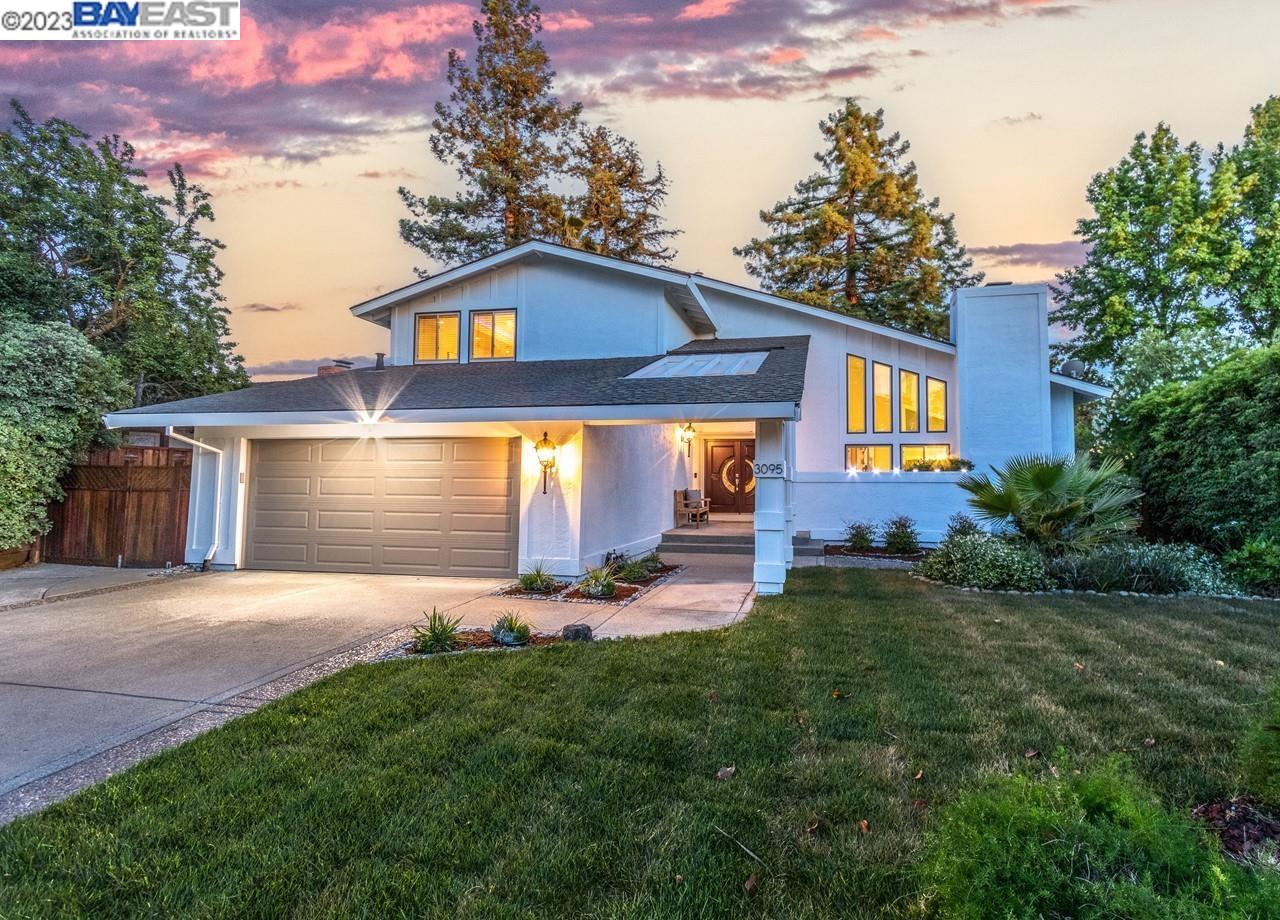 a front view of house with yard and outdoor seating