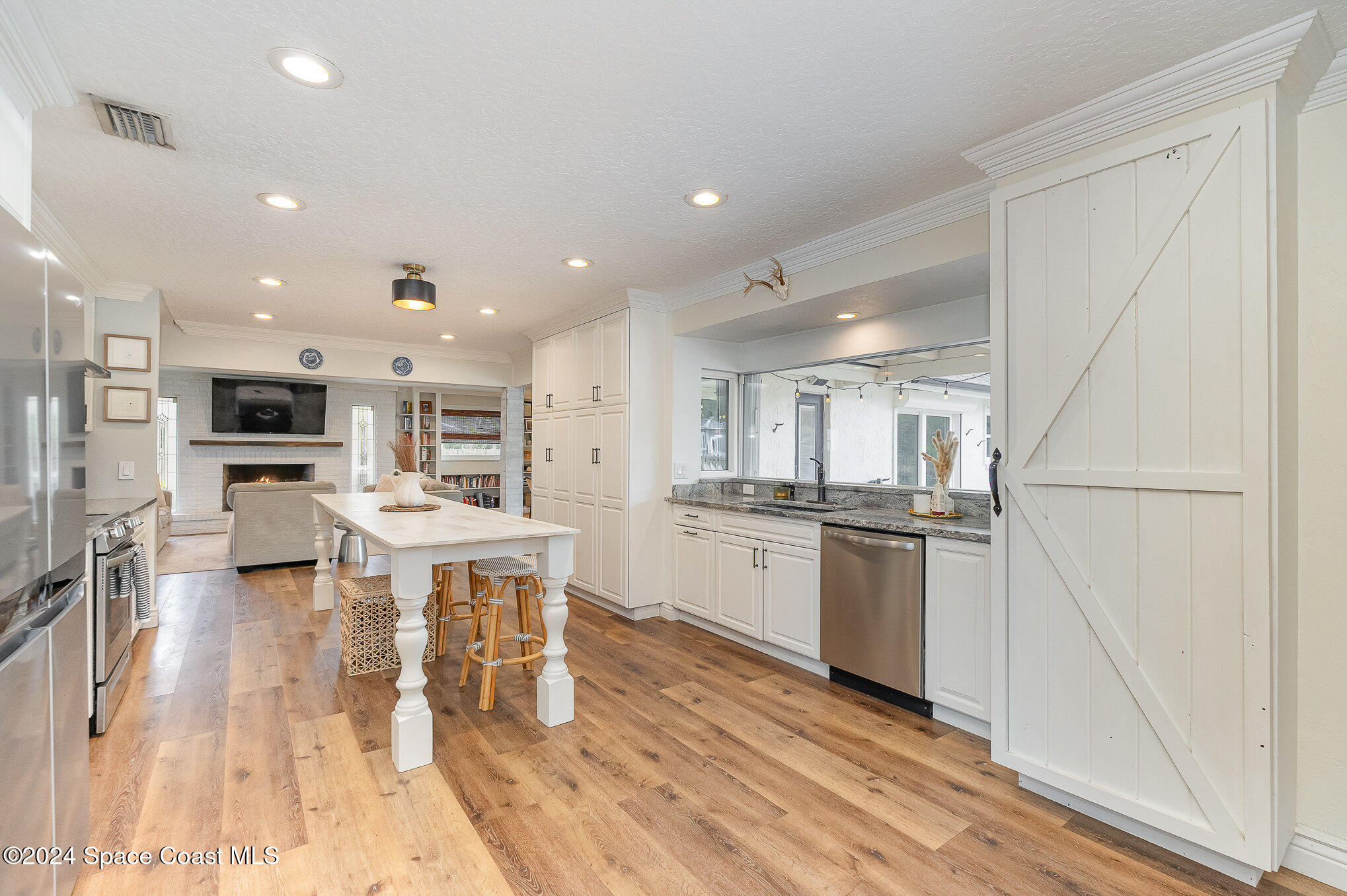 2175 Rockledge Drive Rockledge, FL 32955 - Photo 12 of 48 a kitchen with stainless steel appliances kitchen island granite countertop a stove top oven a sink a dining table and chairs