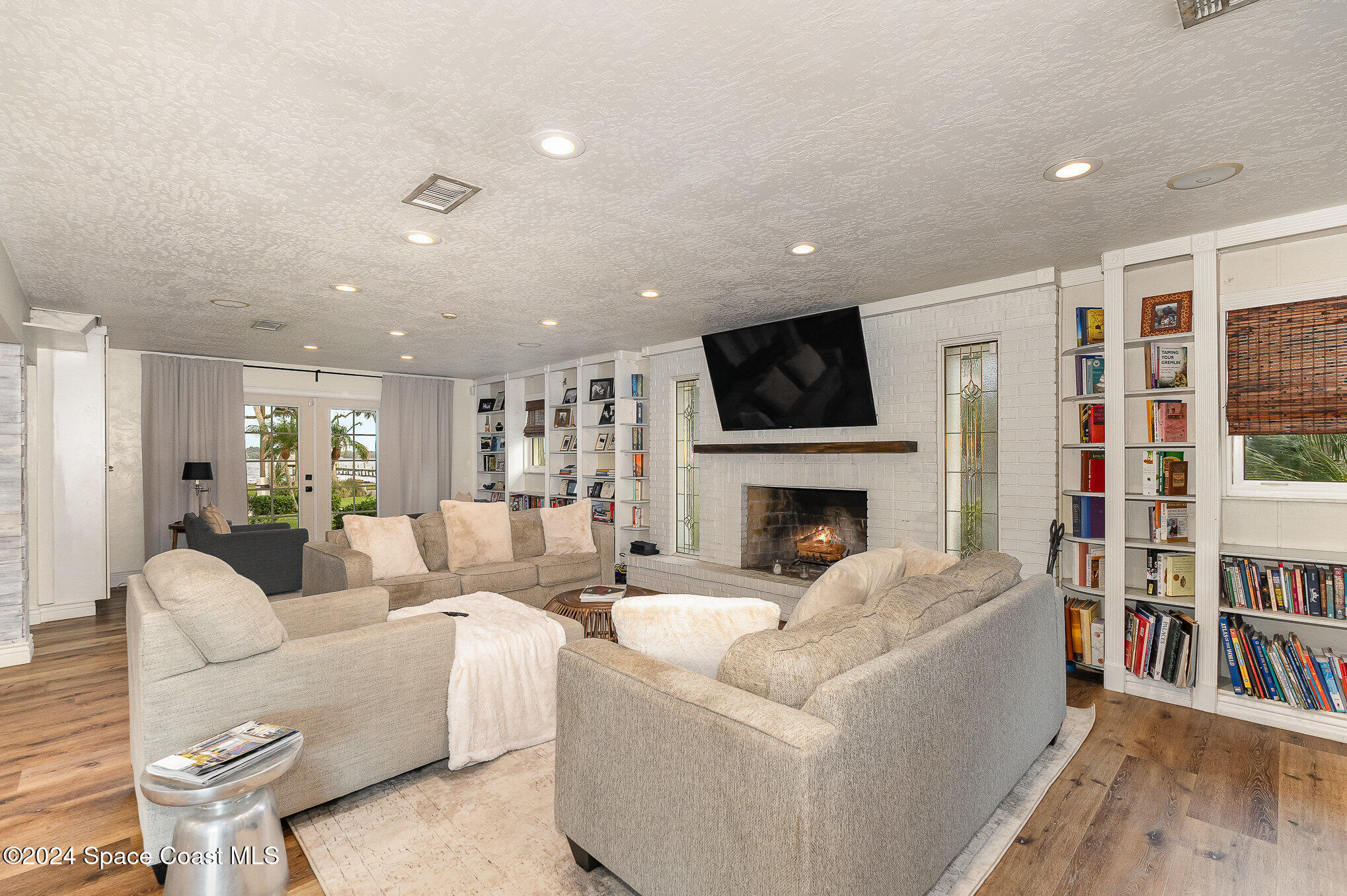 2175 Rockledge Drive Rockledge, FL 32955 - Photo 14 of 48 a living room with furniture a fireplace and a flat screen tv