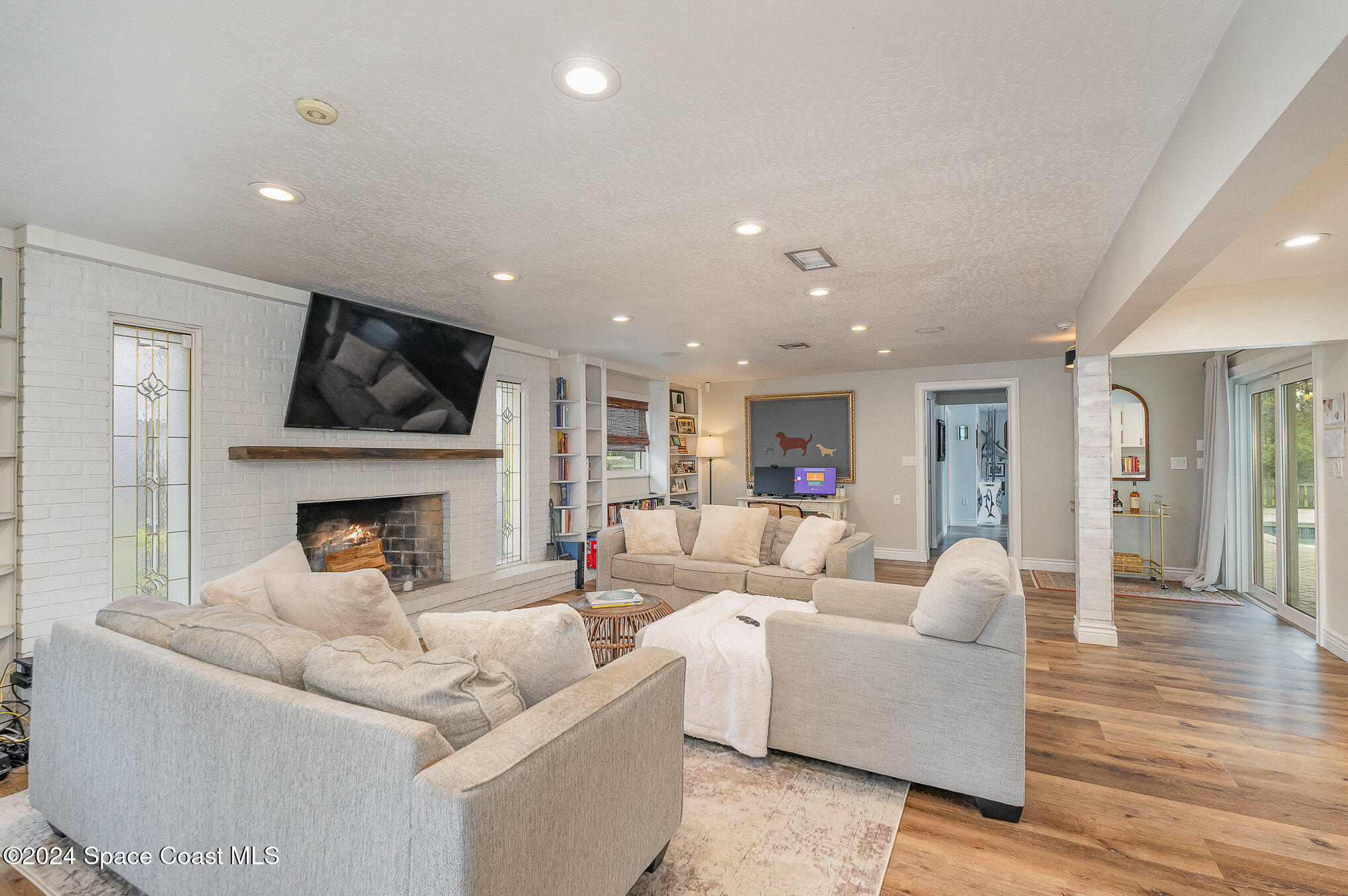 2175 Rockledge Drive Rockledge, FL 32955 - Photo 16 of 48 a living room with furniture a fireplace and a flat screen tv