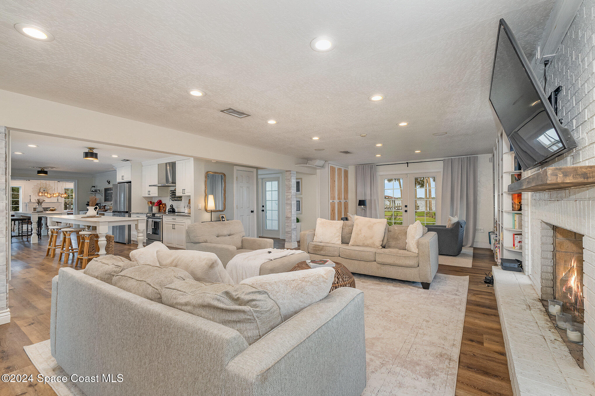 2175 Rockledge Drive Rockledge, FL 32955 - Photo 17 of 48 a living room with furniture a fireplace and a flat screen tv