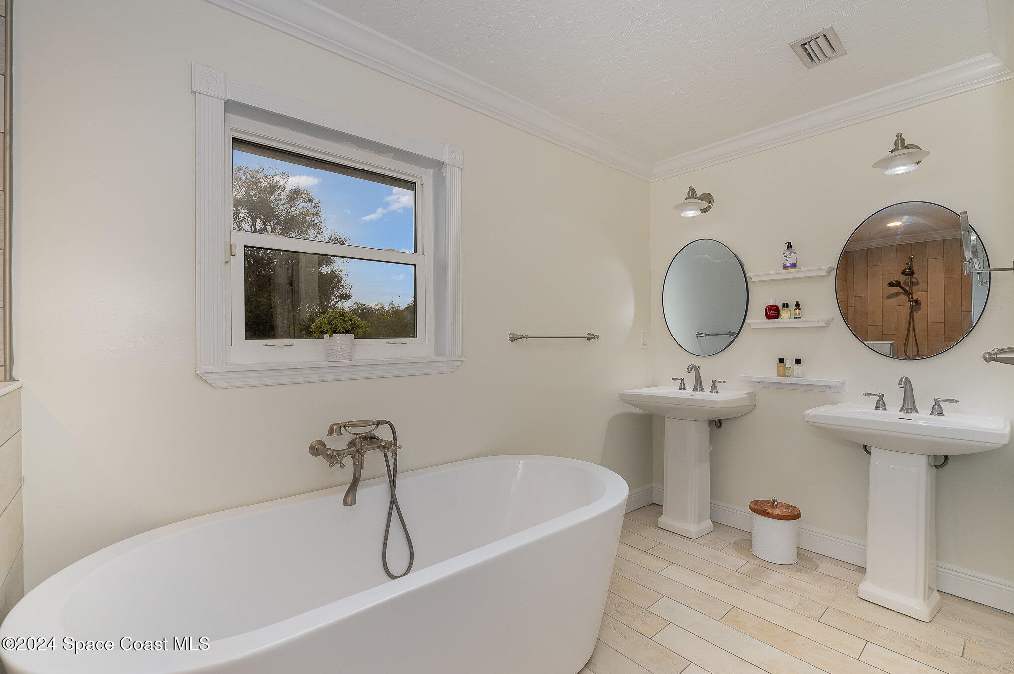 2175 Rockledge Drive Rockledge, FL 32955 - Photo 24 of 48 a bathroom with a tub a sink and a mirror