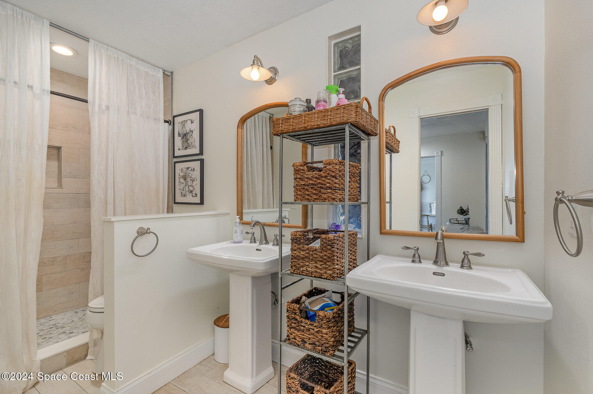 2175 Rockledge Drive Rockledge, FL 32955 - Photo 26 of 48 a bathroom with a sink a mirror and a shower