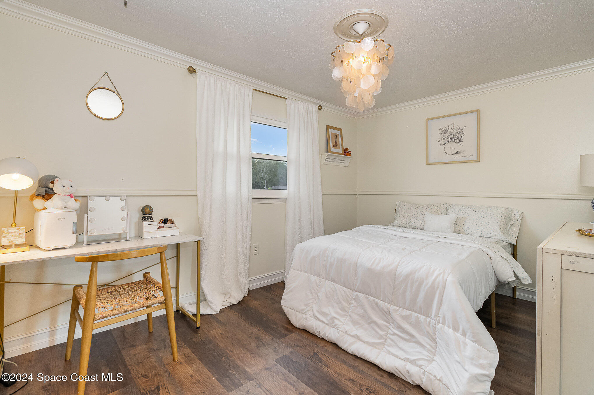 2175 Rockledge Drive Rockledge, FL 32955 - Photo 27 of 48 a bedroom with a bed and a chandelier