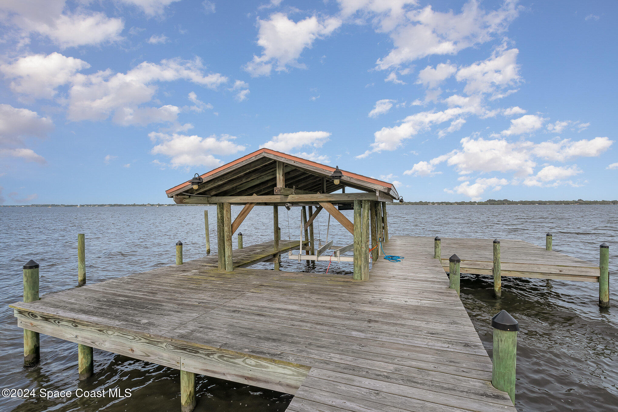 2175 Rockledge Drive Rockledge, FL 32955 - Photo 38 of 48 a roof deck with table and chairs a barbeque with wooden floor and city view
