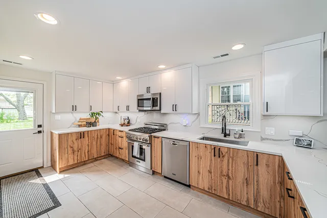 a kitchen with stove top oven sink and cabinets