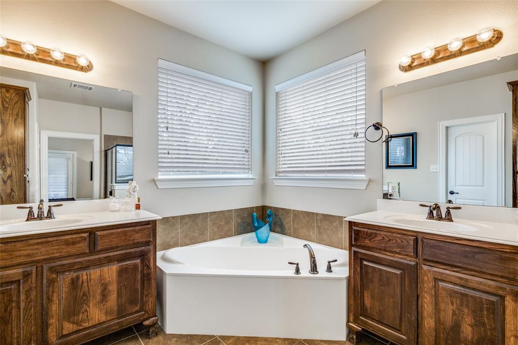 817 Deer Ridge Trail McKinney, TX 75072 - Photo 15 of 35 Big Sooaking tub and his and hers vanities and addition storage cabent on other wall