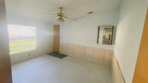 an empty room with windows and closet