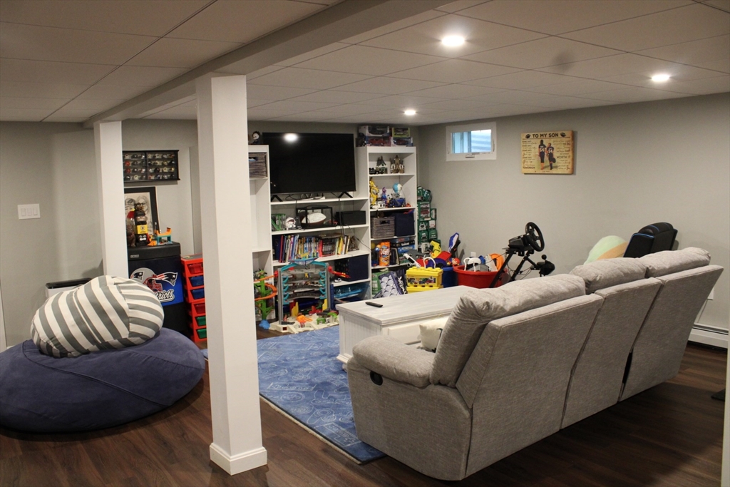 225 Braemoor Road Brockton, MA 02301 - Photo 26 of 29 a living room with furniture and a flat screen tv