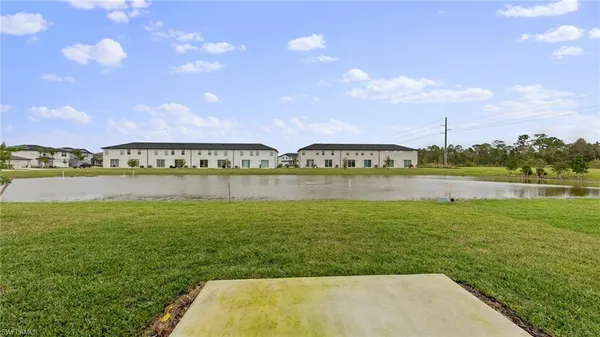 a view of a lake with houses in the back
