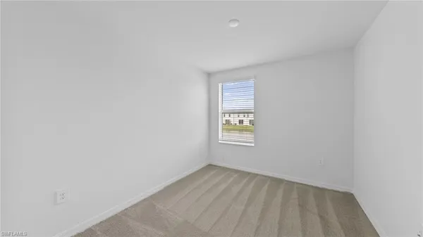 a view of an empty room and a window