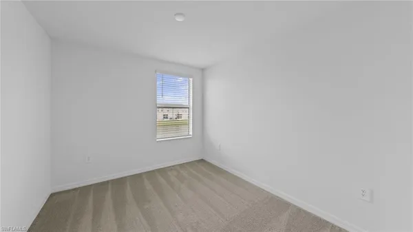 a view of an empty room and a window