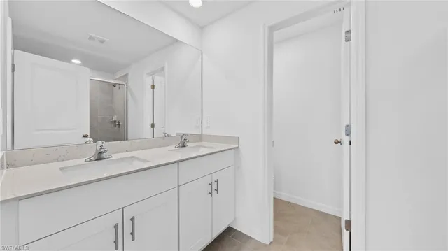 a bathroom with a double vanity sink and mirror