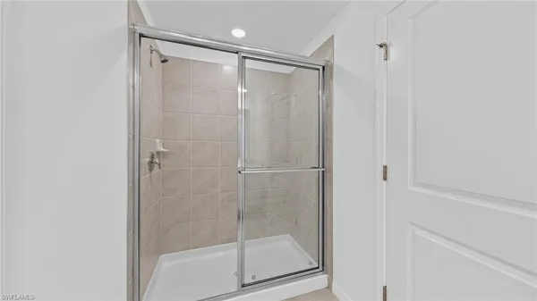 a bathroom with a glass shower door