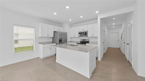 a kitchen with refrigerator cabinets and a sink