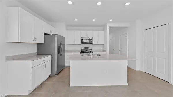 a kitchen with stainless steel appliances a refrigerator and a stove